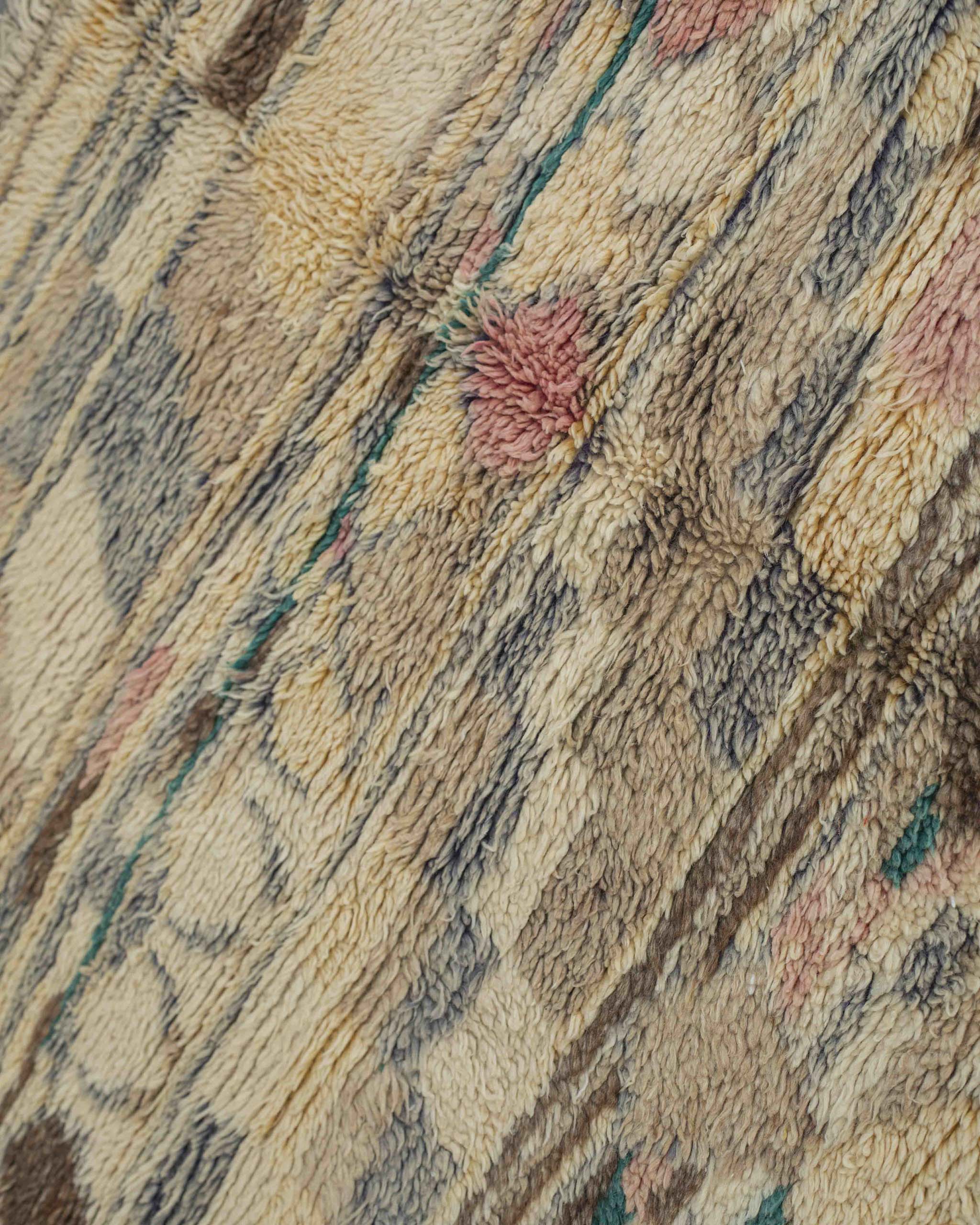 Dettaglio del tappeto in lana a pelo corto in colori polverosi desaturati dal look vintage shabby