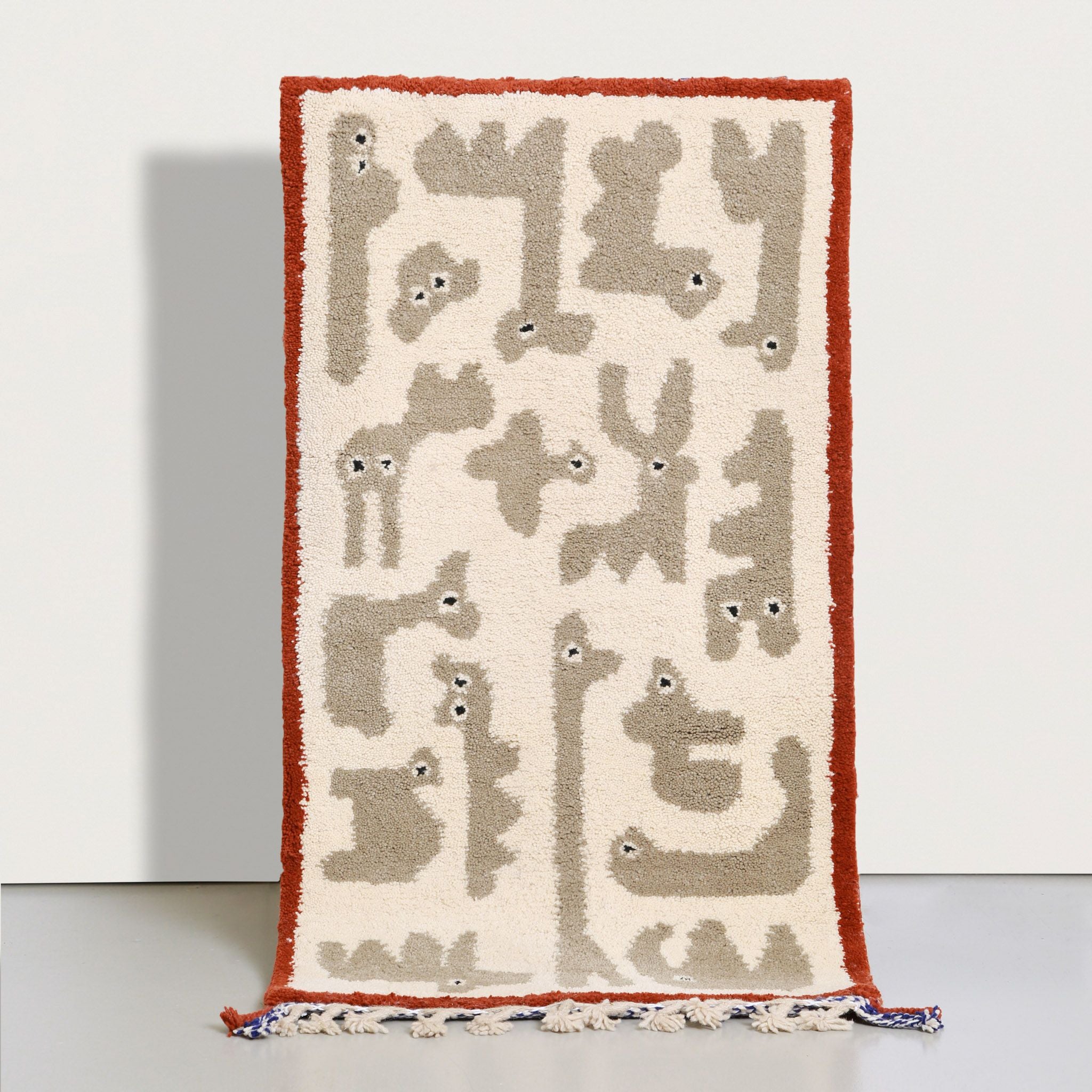 Tappeto Beni Ourain 150x80 cm con motivi animali stilizzati, lana naturale avorio e bordatura terracotta, fatto a mano in Marocco