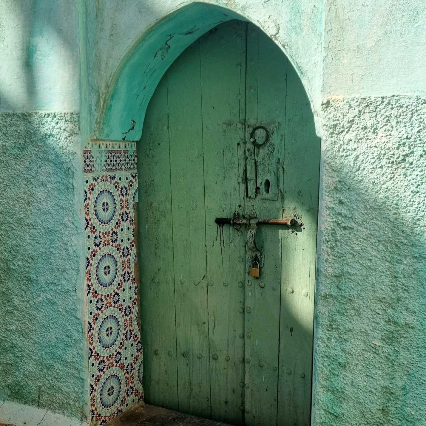 porta e muro verde acqua all'interno della medina di boujaad