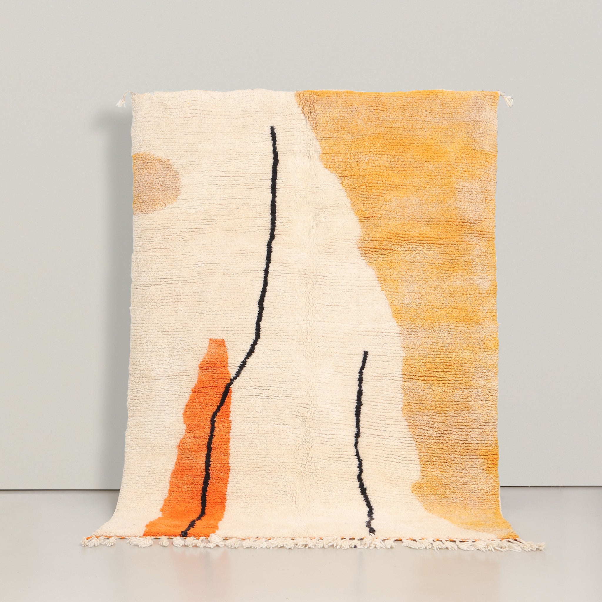 tappeto azilal realizzato a mano in lana su base bianca con due linee irregolari neri un chiazza arancione e un lato giallo sfumato 