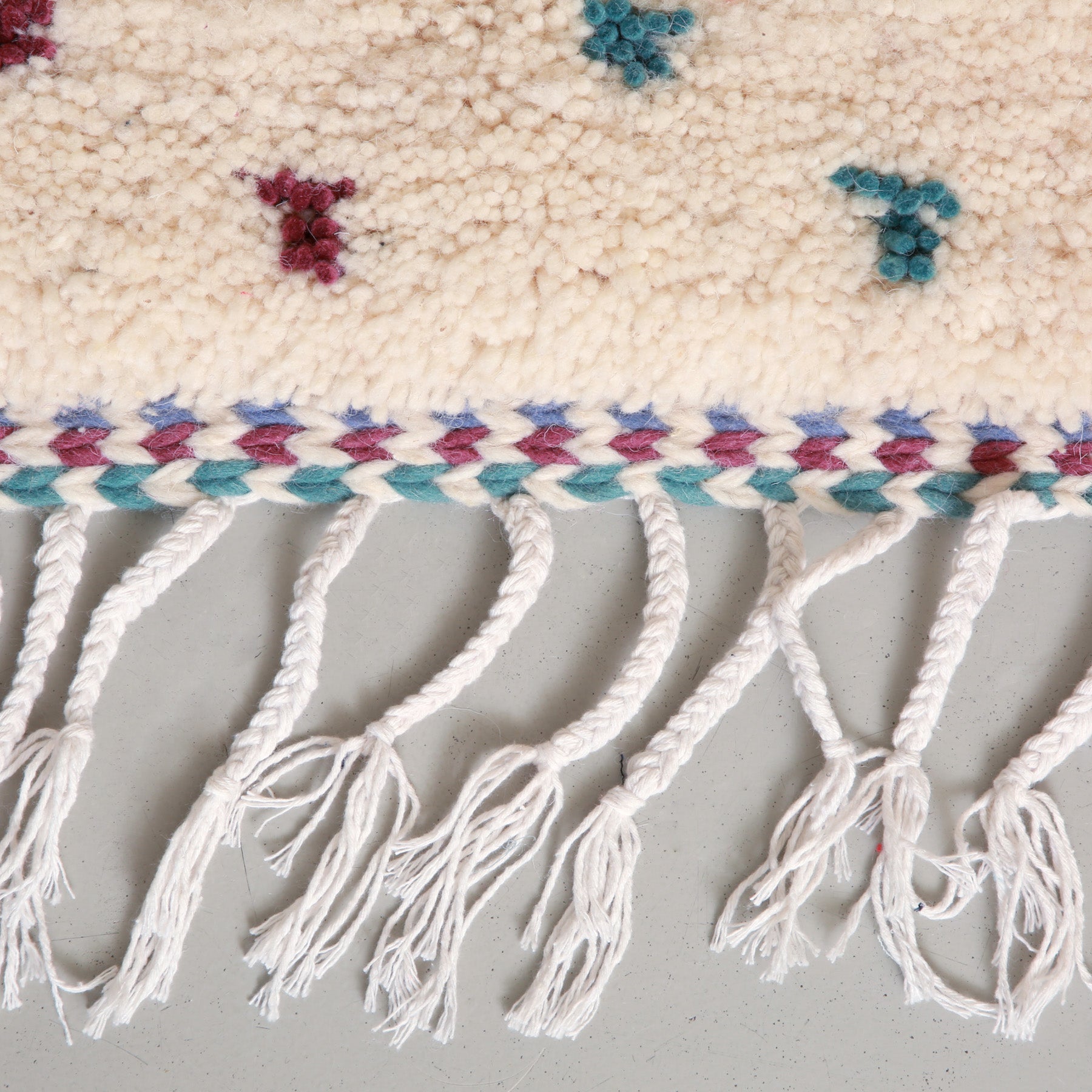 dettaglio della frangia colorata di un tappeto azilal a pois