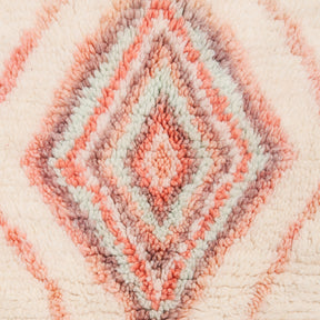 Dettaglio di una serie di rombi un all'interno dell'altro realizzati annodando fili di lana