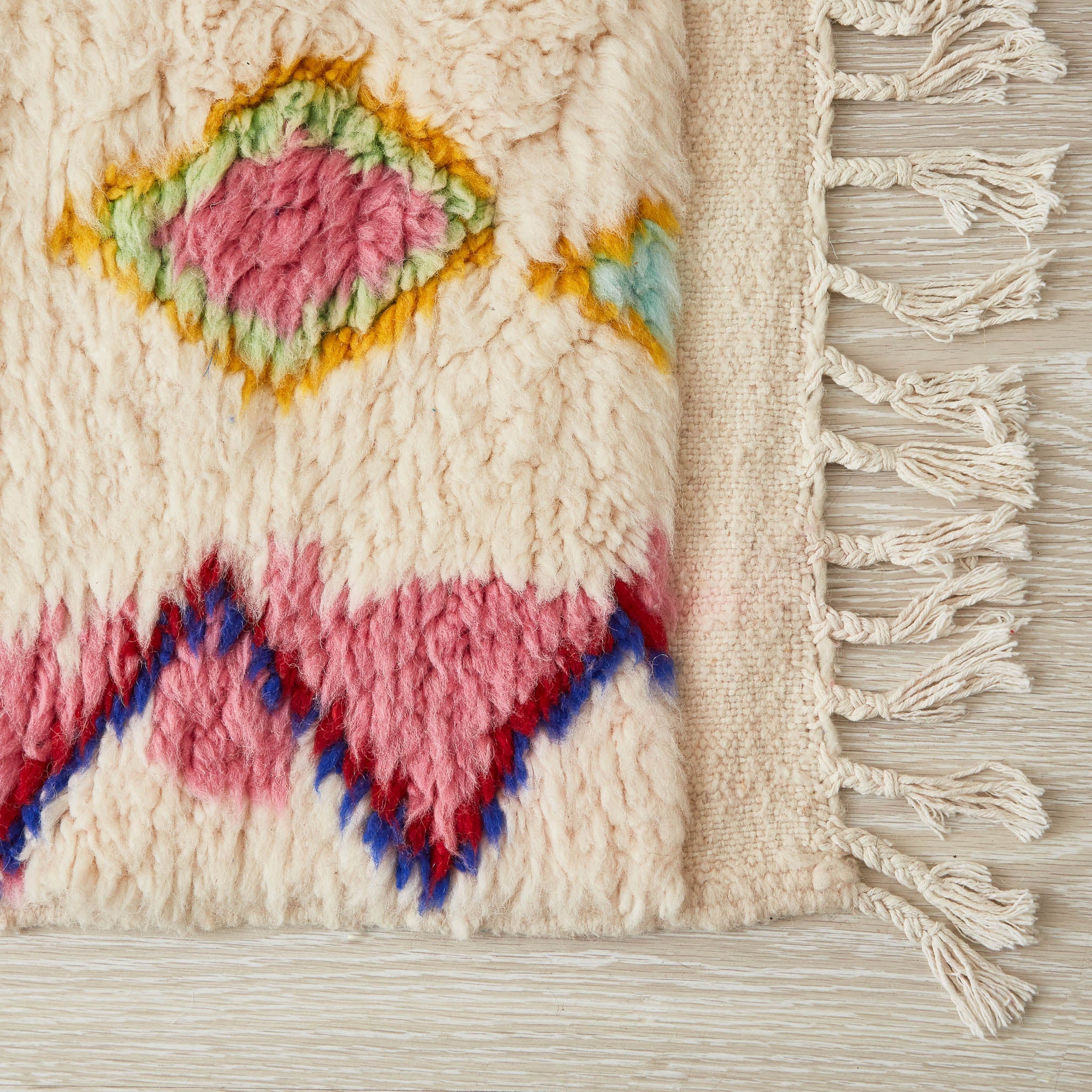 tappeto azilal con rombi e linee dai colori vivaci su base bianca dettaglio angolo e frangia
