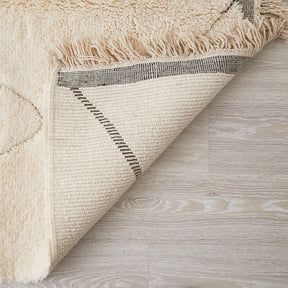 tappeto beni ourain con morbido pelo lungo a tinta unita e disegni geometrici con leggera rasatura dettaglio del retro